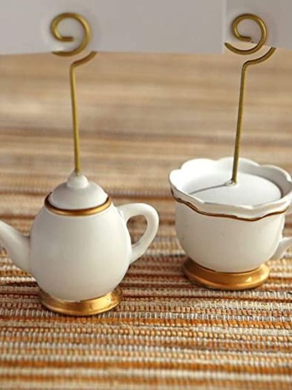 A detailed view of my teapot and teacup place card holders. The white ceramic with delicate gold trim makes them a perfect match for elegant tea parties or bridal brunches.