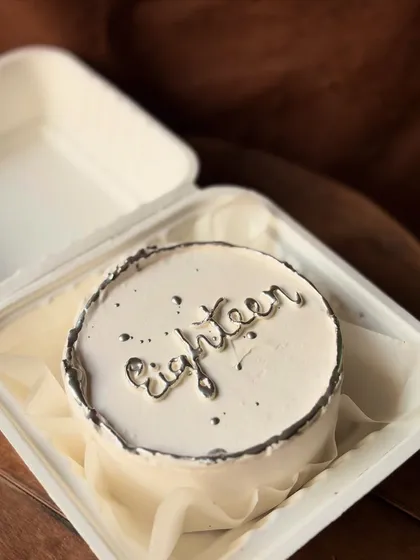 An elegant bento cake for an 18th birthday. I used a silver food-grade paint to create a metallic effect on the lettering and border for a touch of glam.