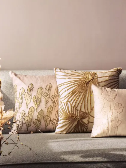 A closer look at our hand-embroidered cushions, showcasing the fine threadwork and sophisticated color palette. These pieces are designed to add texture, warmth, and a touch of nature-inspired beauty to your home.