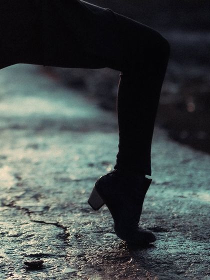 A close-up of a Flamenco shoe on the cracked ground, symbolizing the art's earthy and raw nature.