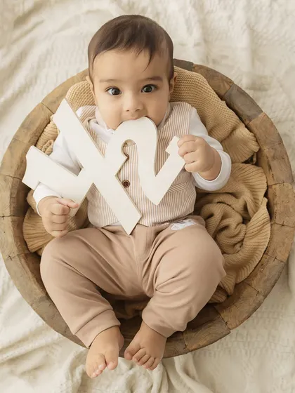 A cute shot of the baby chewing on his "1/2" sign, a funny and real moment from his milestone session.