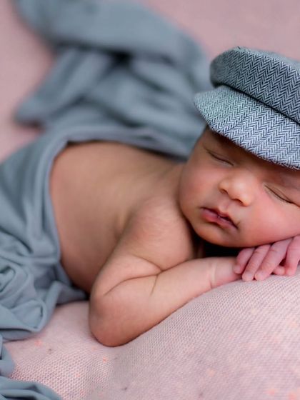 A simple pose can be so powerful. This little gentleman, with his dapper cap, shows how we can capture personality even in the earliest days with minimal props and a focus on your baby.