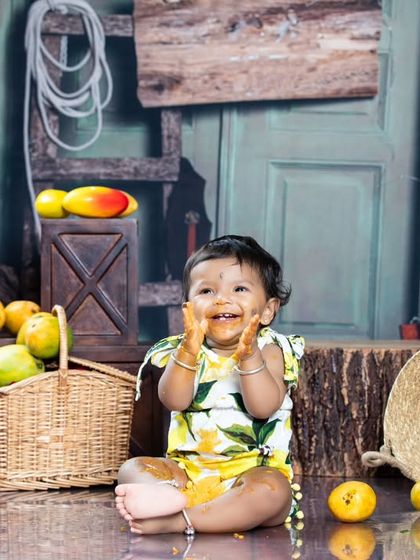 A fun and messy mango-themed shoot! This little one is enjoying the king of fruits.
