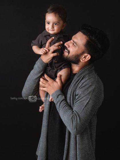 The playful interaction between a father and his baby. Lifting the baby up high brings out natural smiles and laughter, making for a dynamic and joyful father-child portrait.