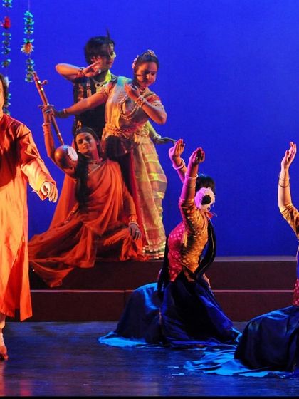 A tableau from a Janmashtami performance, with Pt. Jai Kishan Maharaj at the center. We create visually rich stage compositions that resemble living paintings.