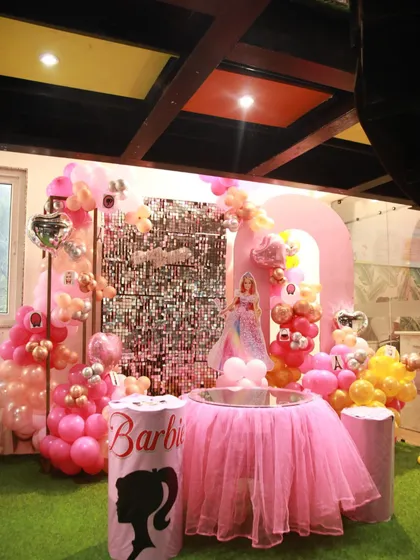 It's a Barbie world! This glamorous Barbie-themed party features a pink sequin wall, a doll display, and lots of sparkle.