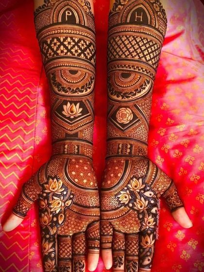 A highly personalized and symmetrical design. This features the couple's initials 'P' and 'H' on the arms, along with lotus and rose motifs, all done with 3D shading.