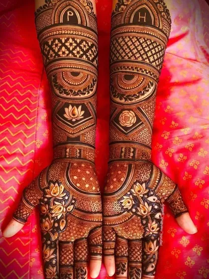 A highly personalized and symmetrical design. This features the couple's initials 'P' and 'H' on the arms, along with lotus and rose motifs, all done with 3D shading.