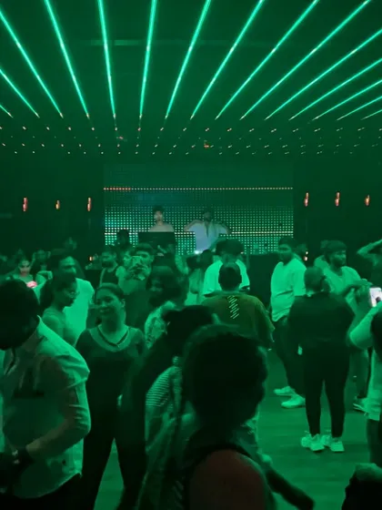 The club bathed in green light. The visual experience is just as important as the audio.