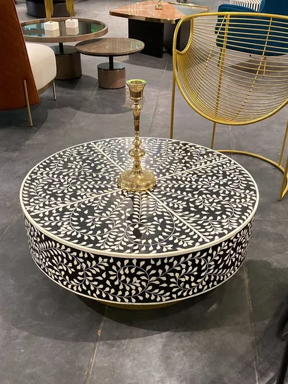 We can't take our eyes off this beautiful bone inlay coffee table. The intricate, handcrafted floral pattern in black and white creates a stunning graphic statement, perfect for adding a touch of artisanal luxury.
