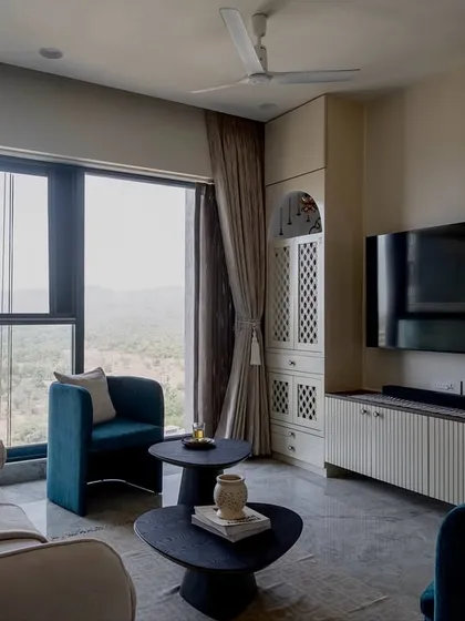 A closer look at the 'Vrindavan' living room. The design balances modern furniture with traditional touches, like the arched mandir cabinet, creating a space that feels both current and timeless.