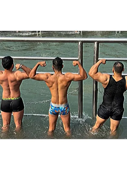 Flexing with friends in the Ganga. We share a bond of both fitness and faith.