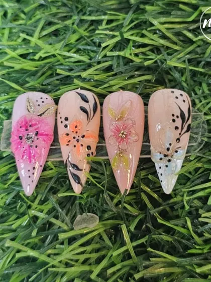 This vibrant set of hand-painted floral nails is the work of a student. It demonstrates their skill in fine line work, color choice, and creating 3D elements to add depth.