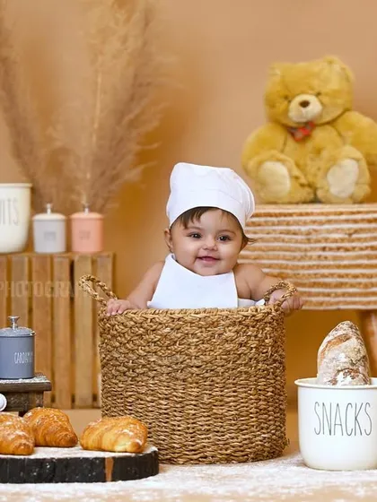 A happy smile from the 'little chef' in this adorable themed studio session.