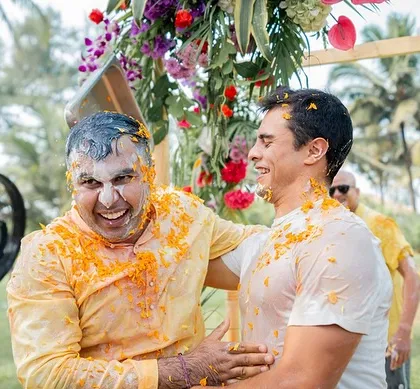 A candid shot of the groom laughing with a friend during the Haldi celebrations.