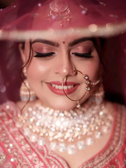 A beautiful shot of the bride with her eyes closed, showcasing the soft and shimmery rose gold eyeshadow.