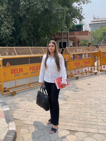 Standing at your defense, ready with legal knowledge and a briefcase full of evidence outside Saket Court.