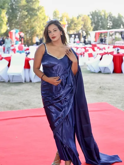 Draped in a satin blue saree for a Women's Day event I hosted for Tata Digital.