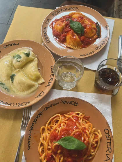A beautiful spread of our hand-rolled pastas, including spaghetti in tomato sauce and cheese-filled ravioli. Making pasta from scratch is a labor of love, and you can taste the difference.