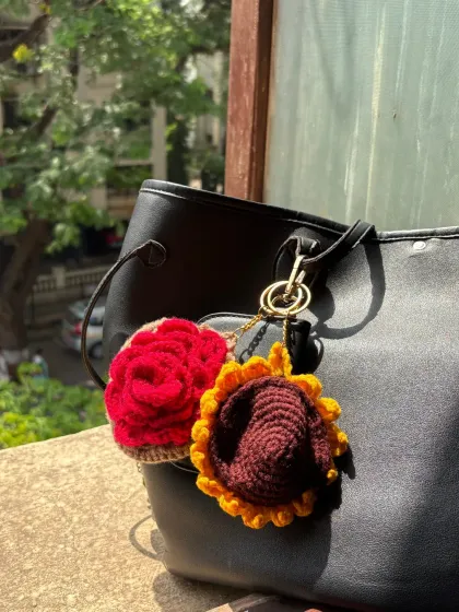 Both the rose earphone case and the sunflower coin purse are shown together here. You can see how they work as a set or as individual statement pieces.