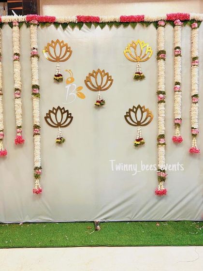 An elegant and simple backdrop perfect for an intimate home function. We used long garlands of fresh jasmine flowers (mallige hoovu) and accented the gray backdrop with golden lotus cutouts for a touch of grace.