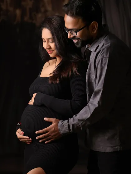 An intimate and gentle moment between expecting parents during their maternity photoshoot. Our goal is to create a comfortable space where you can be yourselves.