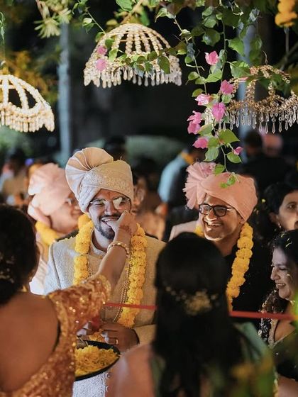 A guest welcomes the groom with a traditional tilak during the wedding rituals. We ensure that all family traditions are beautifully incorporated into the celebration.