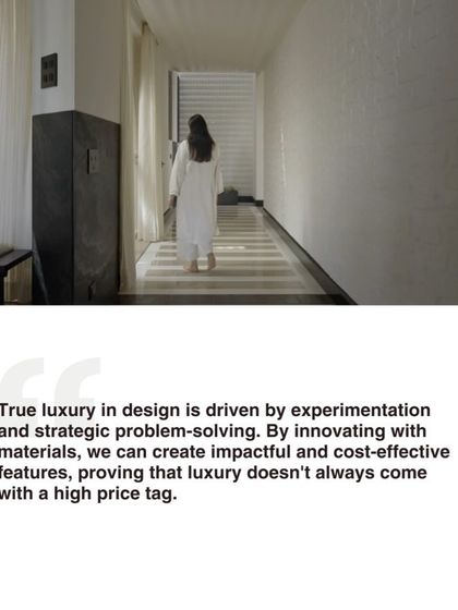 A quote summarizing our philosophy: 'True luxury in design is driven by experimentation and strategic problem-solving.' This image shows a person walking down a corridor with innovative flooring.