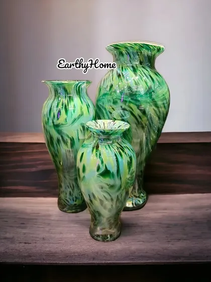 This set of three green marbled glass vases can be used together or separately to display flowers beautifully.