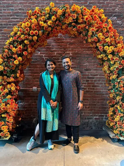 Another photo with a dear friend and colleague from the Monsoon Wedding family, set against the beautiful marigold arch from the show's set.