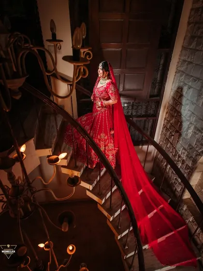 A bride's portrait should be as grand as she feels. We used the dramatic spiral staircase and the long, flowing veil to create a regal and elegant photograph that feels like a piece of art, celebrating the bride in all her glory.