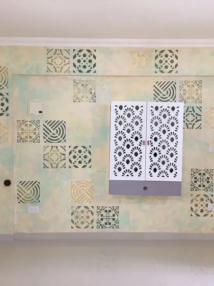 This entryway wall features a unique patchwork of different stencil designs over a soft, cloudy texture. We combined various geometric and traditional tile patterns to create a visually engaging and welcoming space that reflects the home's personality.