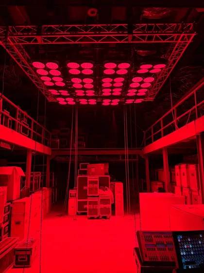 The full 16-unit MegaBrute rig glowing red in our warehouse. This setup can produce an incredible amount of colored light for large-scale scenes.
