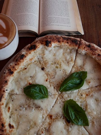 A book, a coffee, and a pizza. My kind of therapy session.