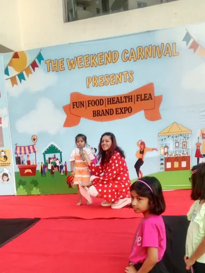Events should be fun for everyone, including the little ones. Here I am on stage at The Weekend Carnival, sharing the microphone with a young participant. I ensure my events are family-friendly and interactive for all age groups.