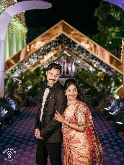 A classic portrait of the couple at their reception, looking elegant and happy.