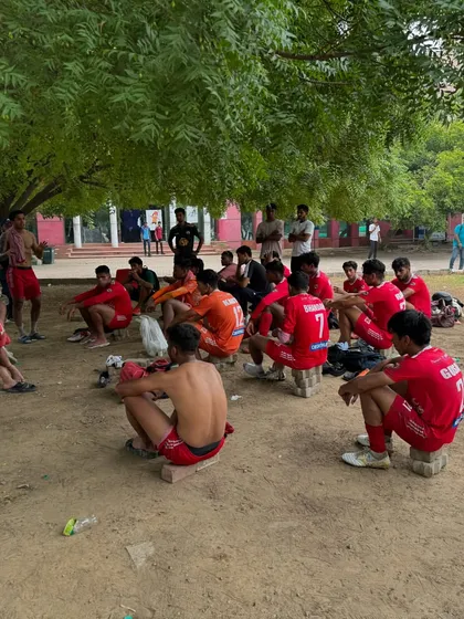 The team resting and rehydrating during a halftime break, a raw look at the physical demands of competitive football.
