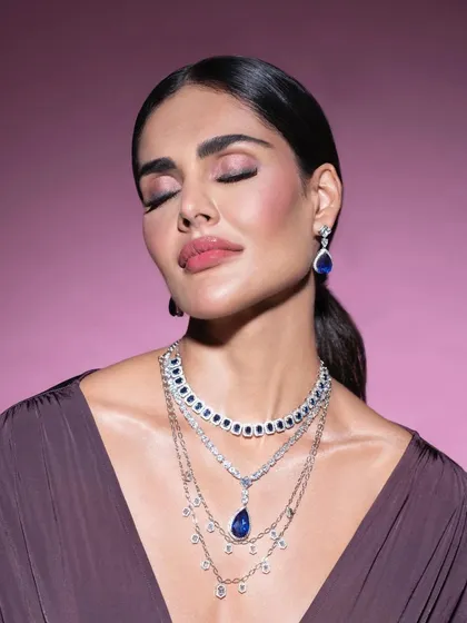 Another angle from our sapphire jewelry shoot, capturing a moment of peaceful elegance. The styling and pose are designed to highlight the full necklace set against the skin.