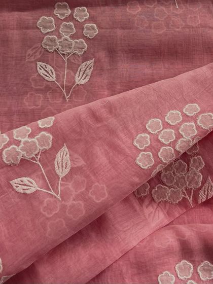 Featherlight Mul Chanderi with delicate appliqué work. The floral motifs are stitched onto the sheer fabric, creating a beautiful, dimensional effect.