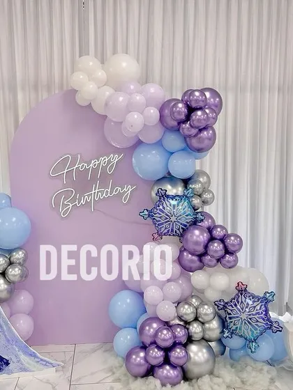A complete Frozen-themed setup for a 5th birthday. It includes an Elsa cutout, a '5' marquee number, and a balloon garland with snowflake foil balloons for that perfect wintery touch.
