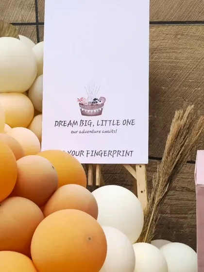 An interactive guest activity where friends and family can leave their fingerprint on a "Dream Big, Little One" poster, creating a unique keepsake for the baby.