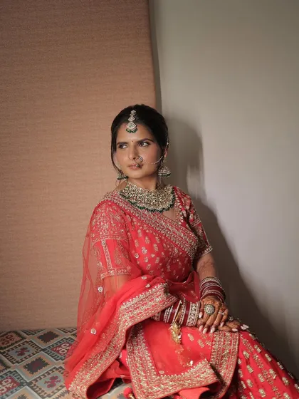 A beautiful portrait capturing the bride's serene moment before the ceremony. The makeup is soft and timeless, designed to photograph beautifully in any light.