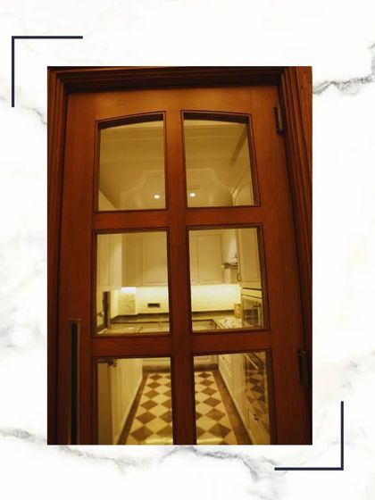 A beautiful glass-paneled wooden door that allows light to flow between the kitchen and the hallway while still providing a sense of separation. The design is both practical and elegant.