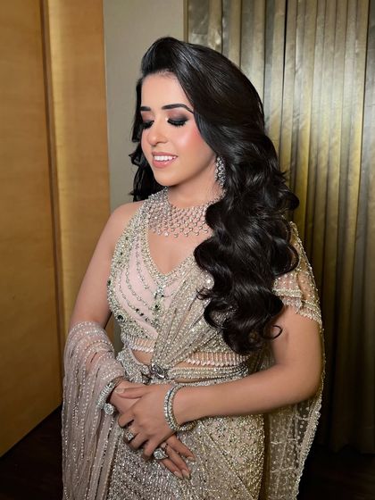 The bride's serene expression, her Hollywood waves and sparkling dress creating a picture of elegance.