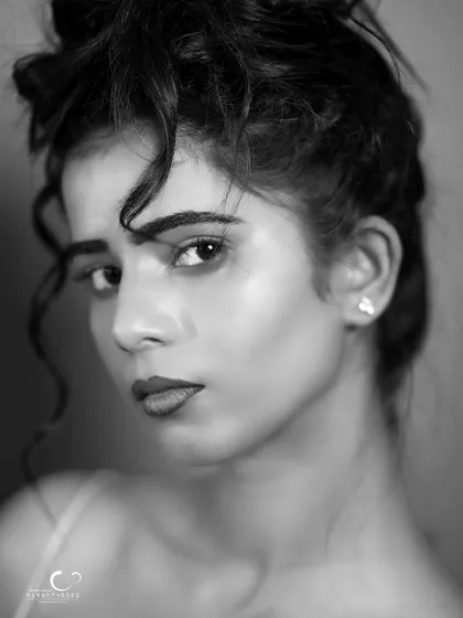 A soft and beautiful black and white beauty shot. The lighting is gentle, and her expression is serene and engaging.