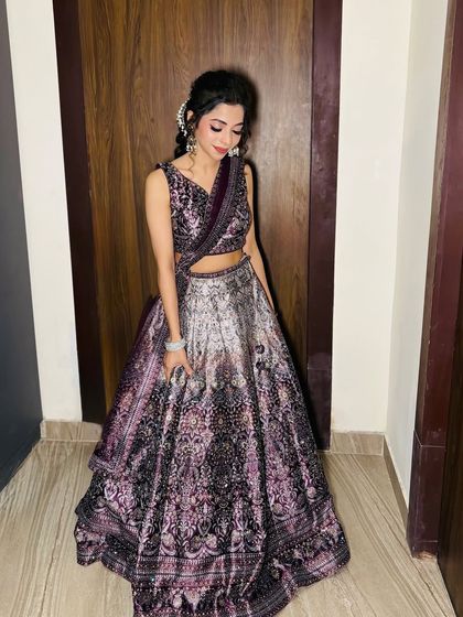 A unique party look with a printed purple lehenga and an intricate braided hairstyle.