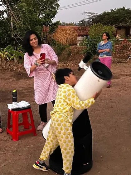 Even the youngest participants get to explore the universe. A child looks through a telescope at our Sky Gazing event, embodying the spirit of curiosity we nurture.