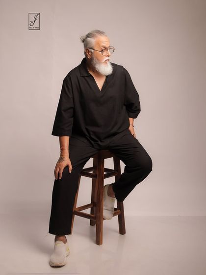 A seated pose that conveys a sense of contemplation and ease, perfect for lifestyle or mature fashion branding.