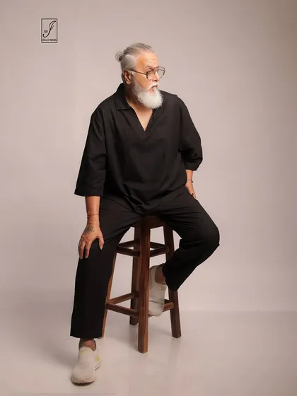 A seated pose that conveys a sense of contemplation and ease, perfect for lifestyle or mature fashion branding.