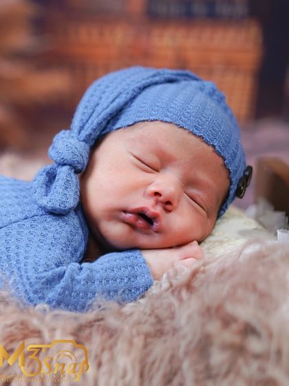 A beautiful profile shot of the newborn sleeping. This angle captures the sweet curve of his cheek and lips.